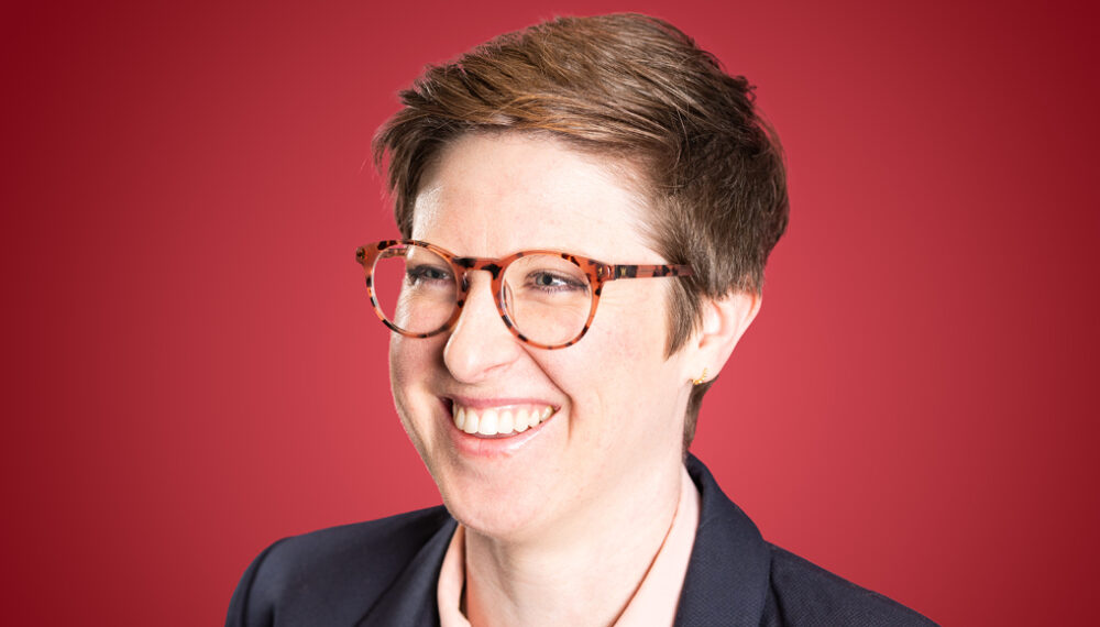 Regional Underwriter Sam Linton in Red Background